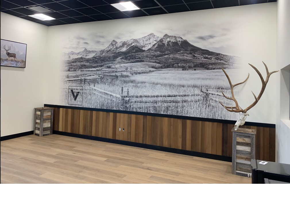 Black and white mountain valley mural with split-rail fence in a rustic office